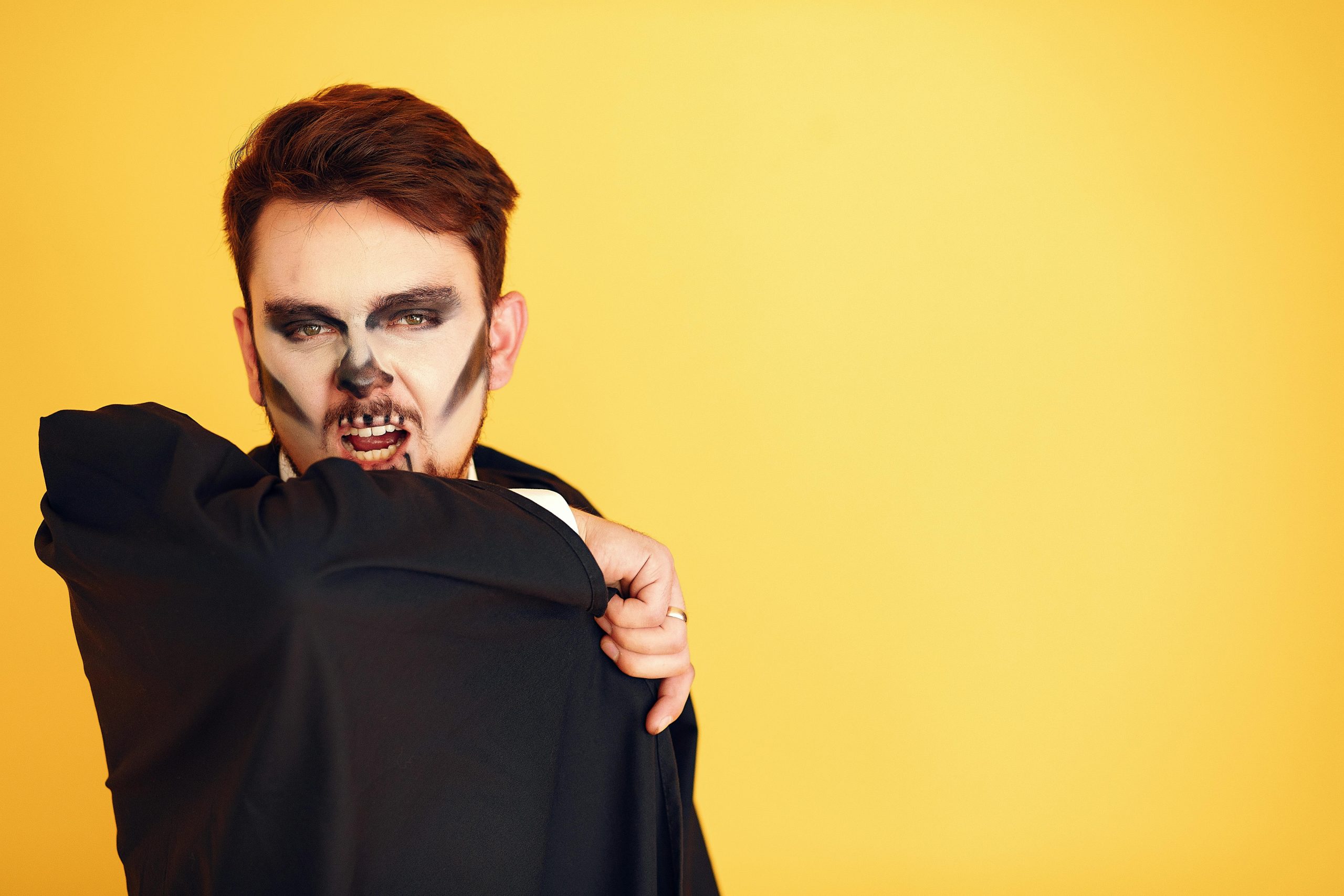Vampire-themed makeup with sharp fangs and glowing eyes