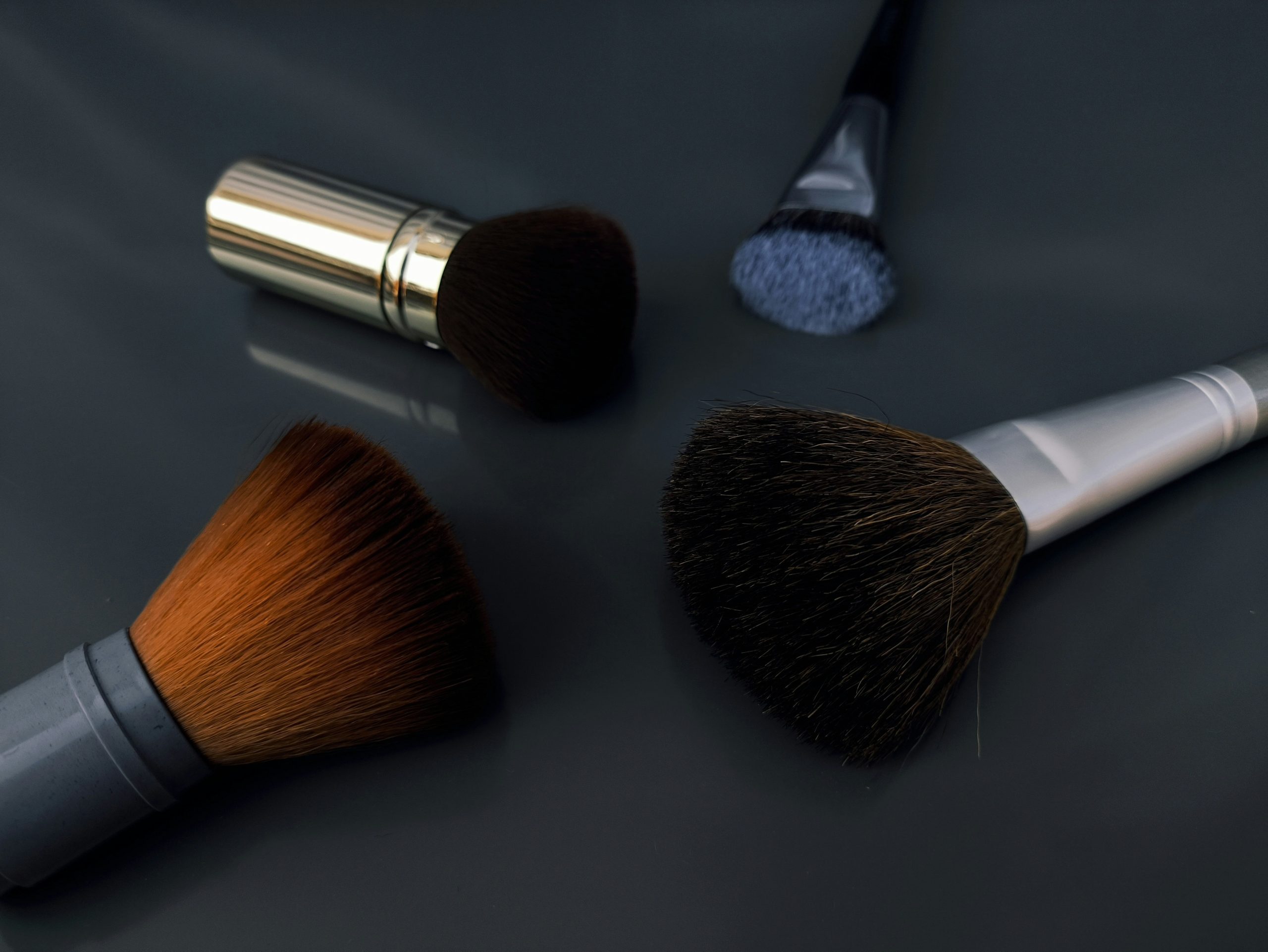 A close-up image of brushes, sponges, and palettes used for Halloween makeup.