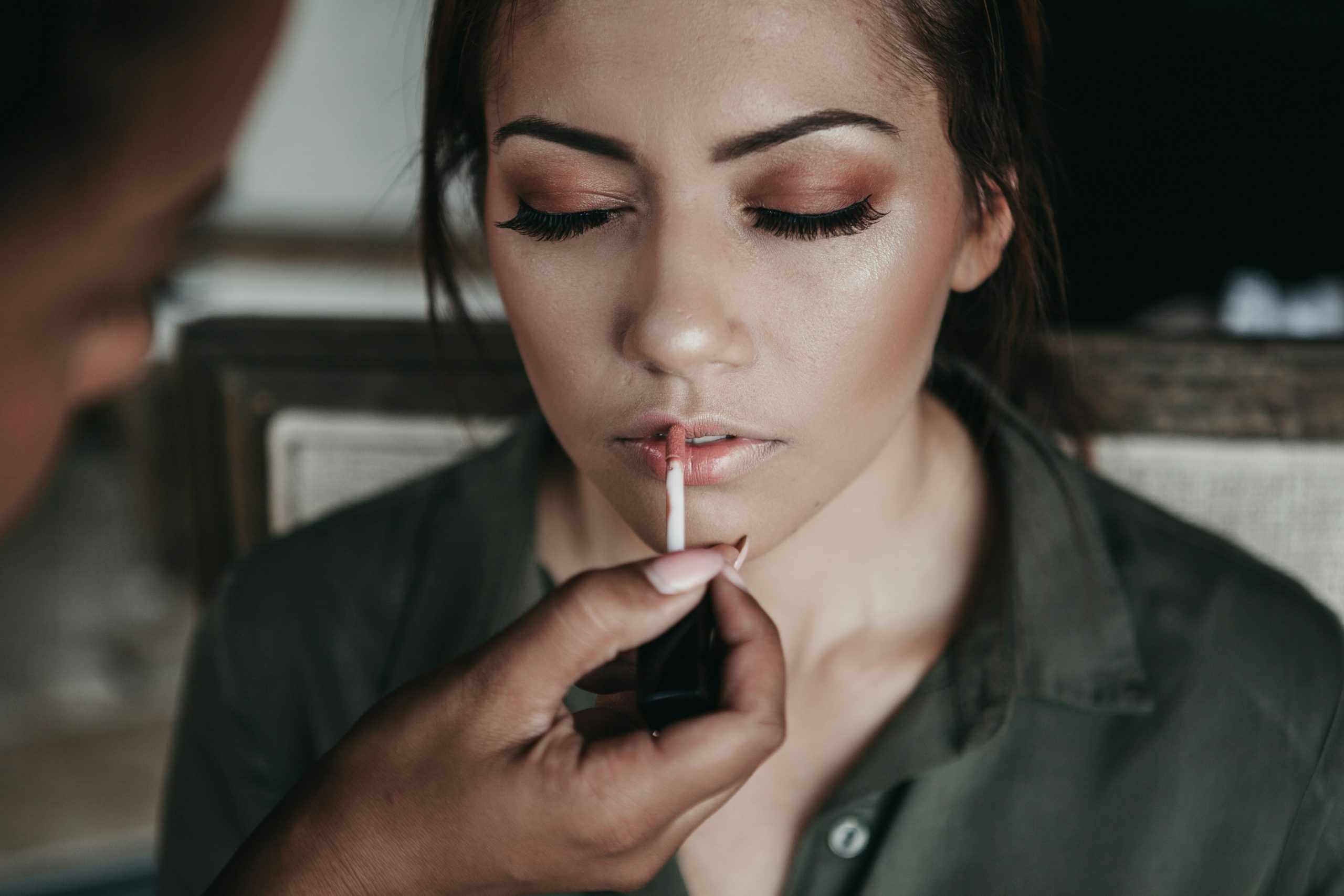 Person applying moisturizer before starting makeup application