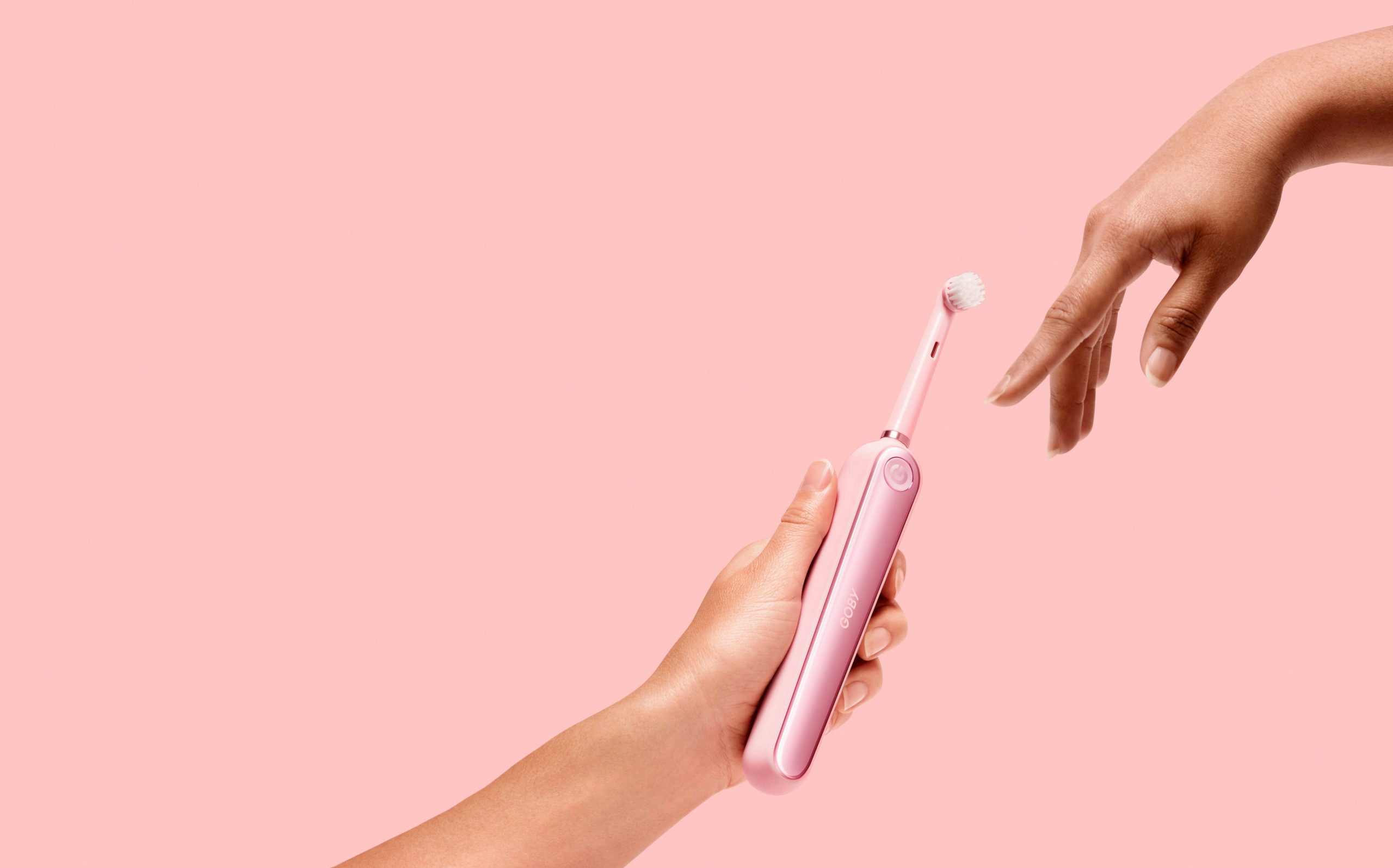 Applying setting spray to face with large brush
