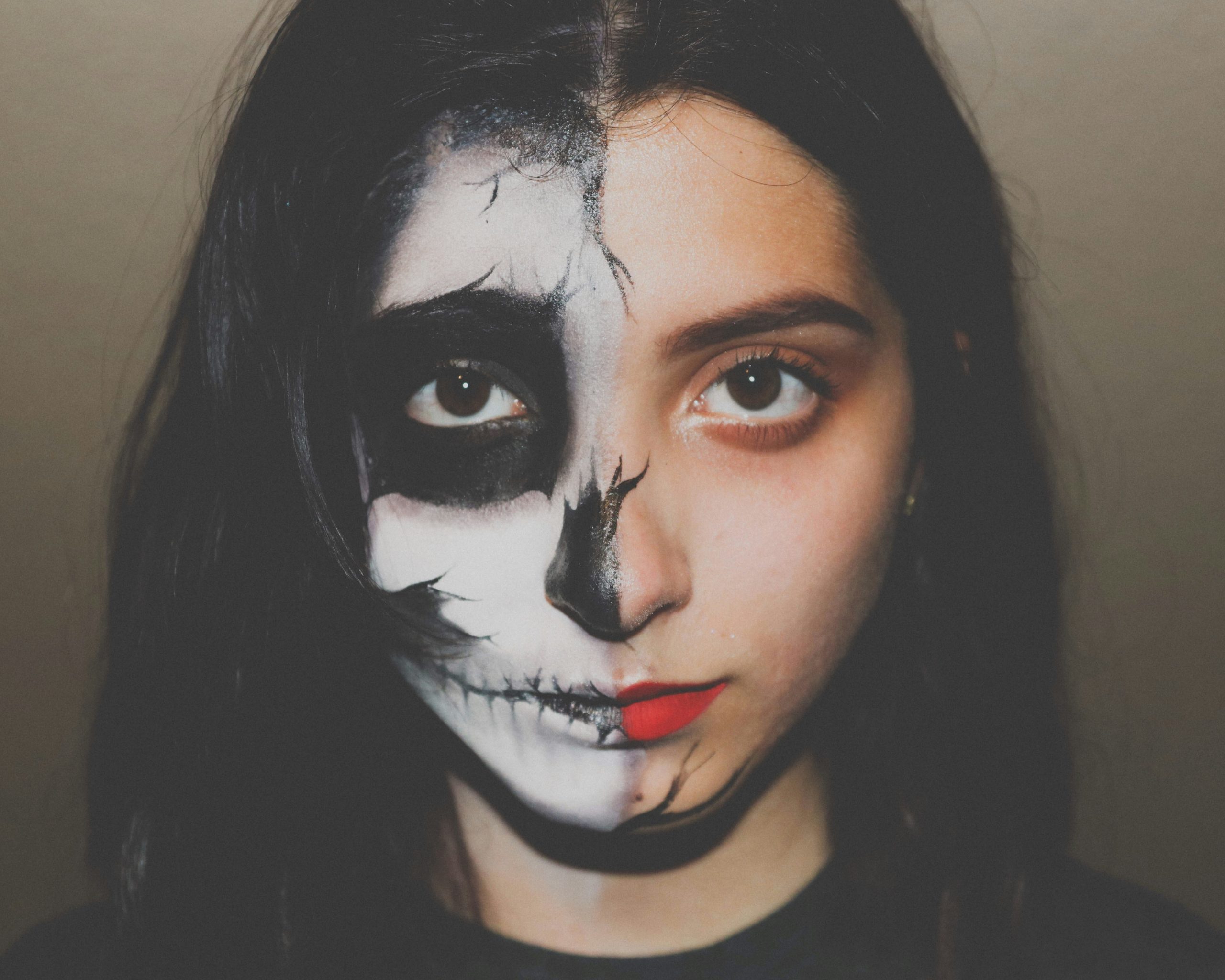 Woman applying prosthetic wound during Halloween party prep