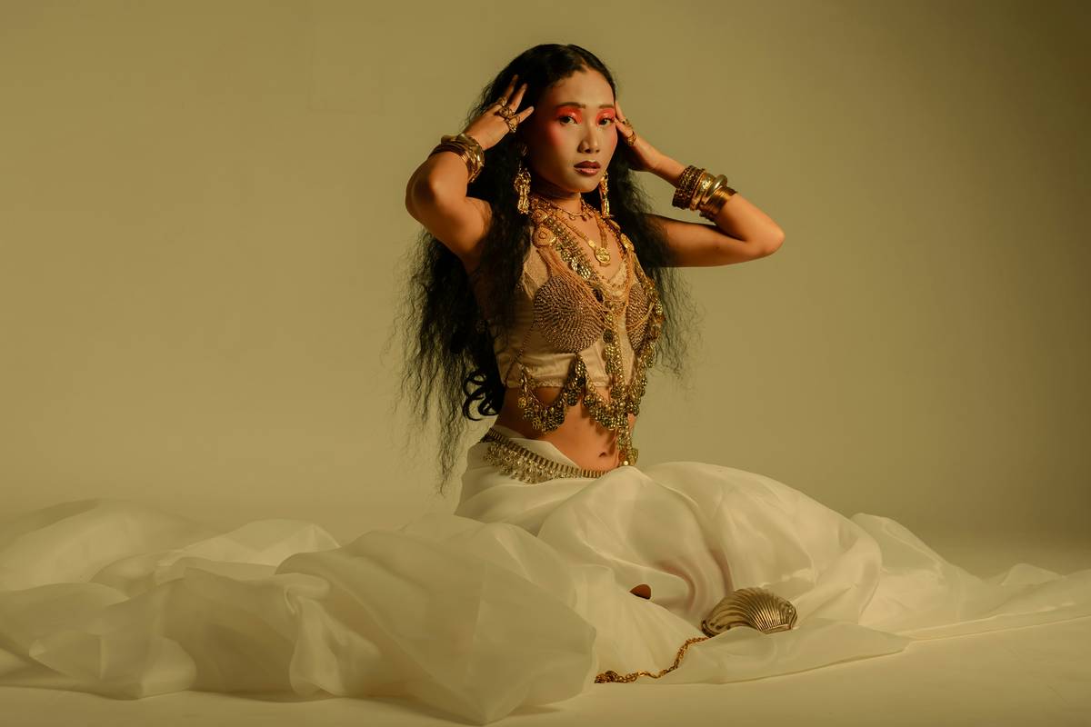 A person wearing pumpkin face makeup with uneven lines and fading color.