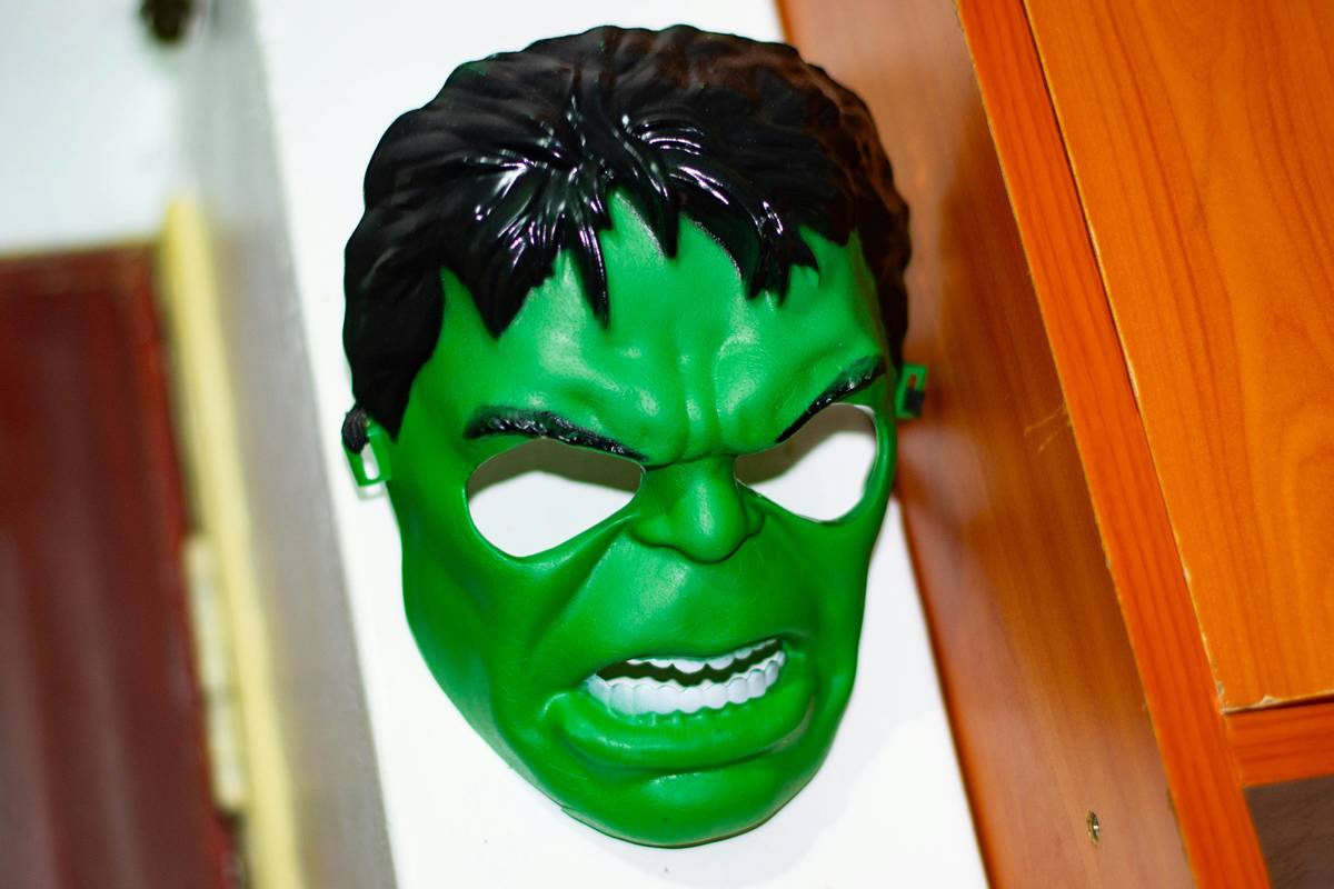 Essential tools for superhero makeup including face paints, brushes, and glitter gels