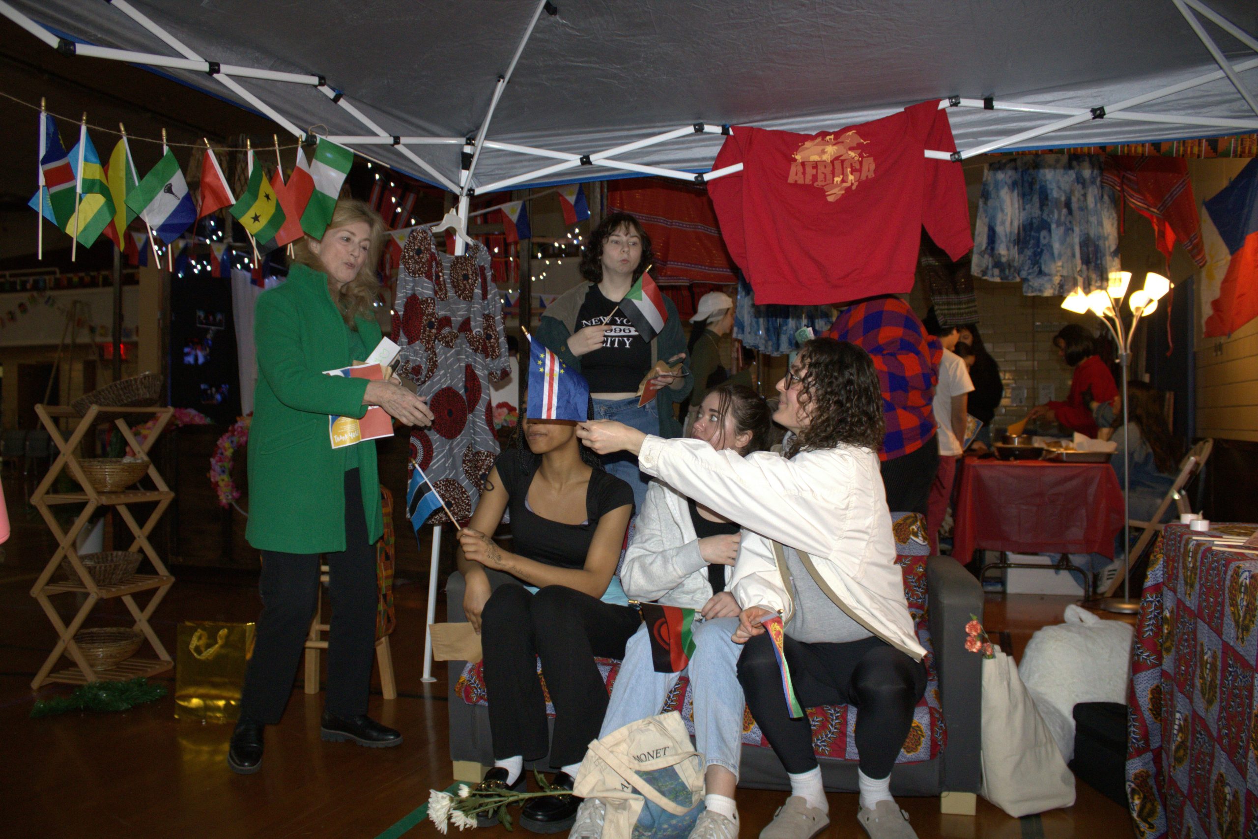a group of people standing under a tent